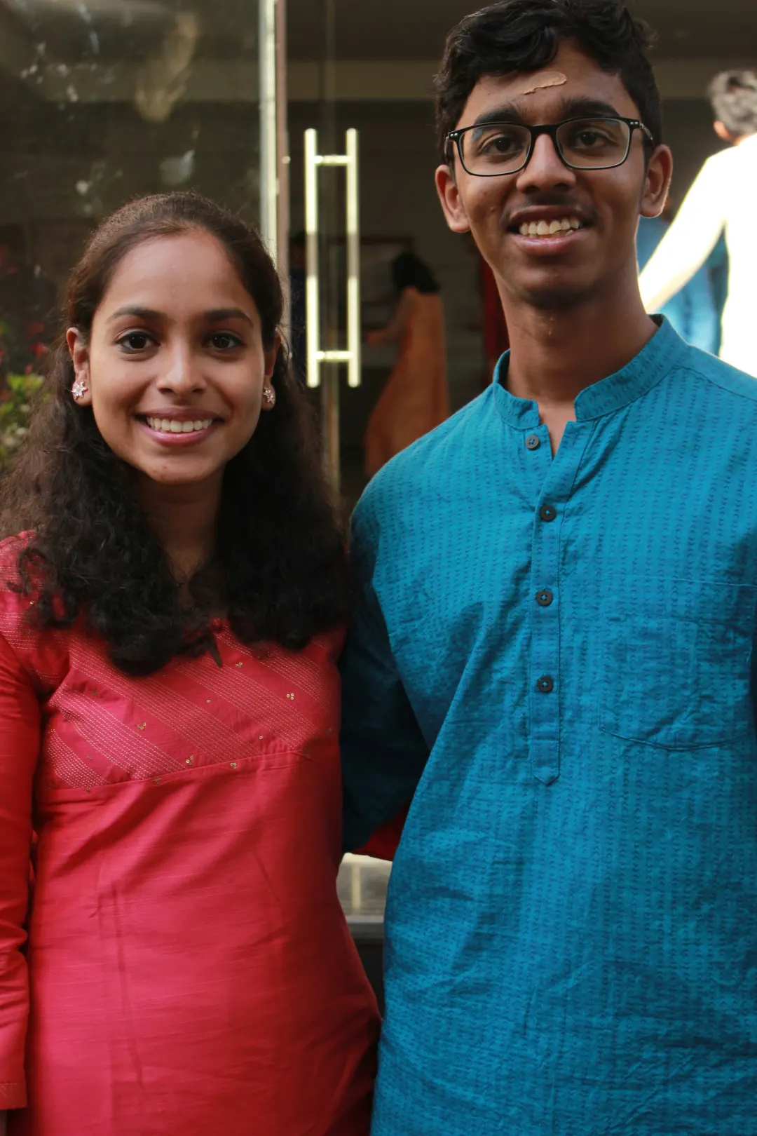 Two young people smiling side by side